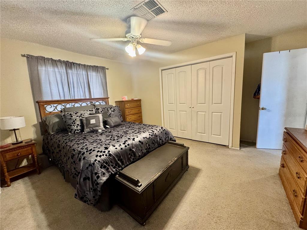 13188 Delbarton Street Spring Hill, FL 34609 - Photo 11 of 23 a bedroom with a bed dresser and a window