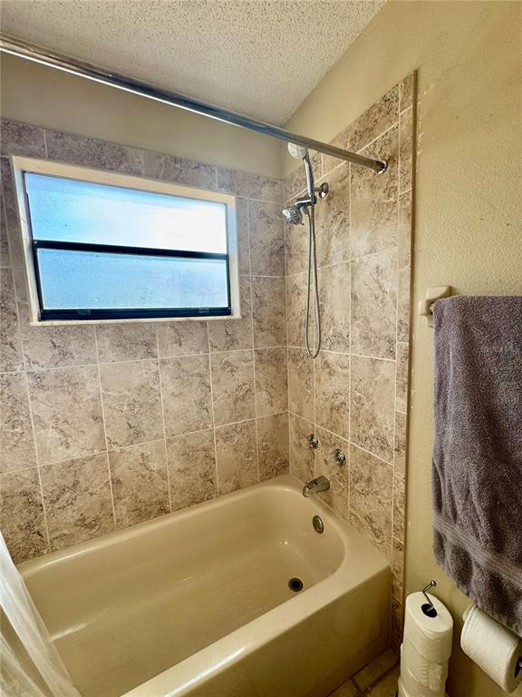13188 Delbarton Street Spring Hill, FL 34609 - Photo 14 of 23 a bathroom with a bath tub and a shower