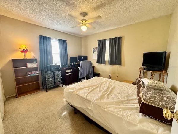 a bedroom with a bed dresser and a window