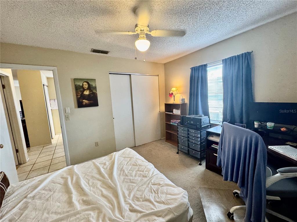 13188 Delbarton Street Spring Hill, FL 34609 - Photo 16 of 23 a bedroom with a bed dresser and a window