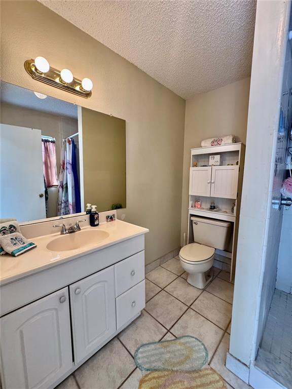 13188 Delbarton Street Spring Hill, FL 34609 - Photo 17 of 23 a bathroom with a toilet sink and mirror