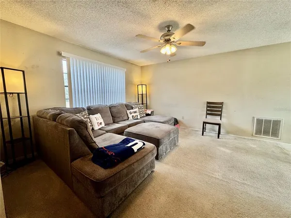 a bedroom with furniture and a flat screen tv