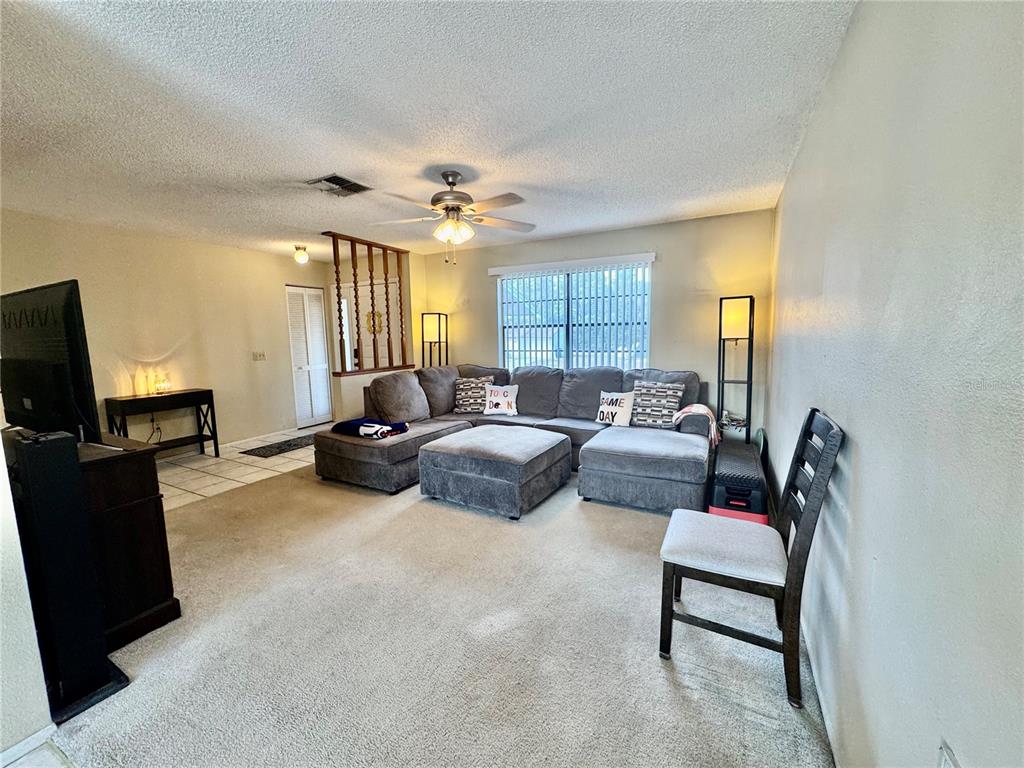 13188 Delbarton Street Spring Hill, FL 34609 - Photo 5 of 23 a bedroom with furniture and a flat screen tv