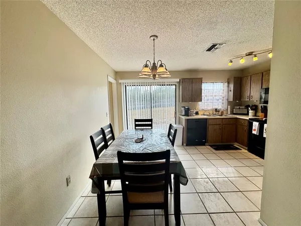 a view of a dining room with furniture a rug and wooden floor