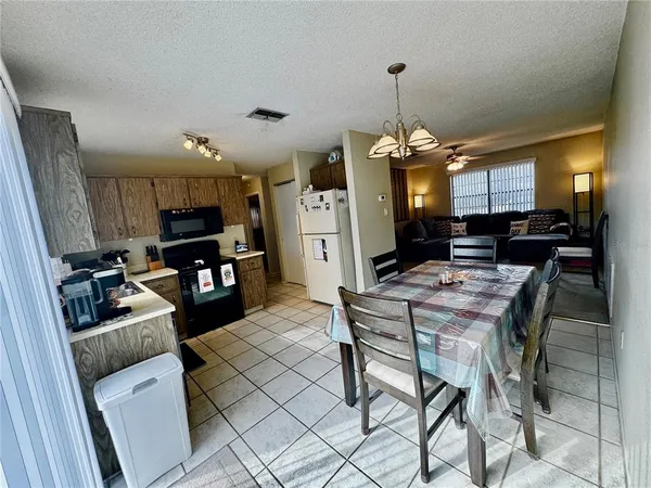 a kitchen with granite countertop a refrigerator sink and stove