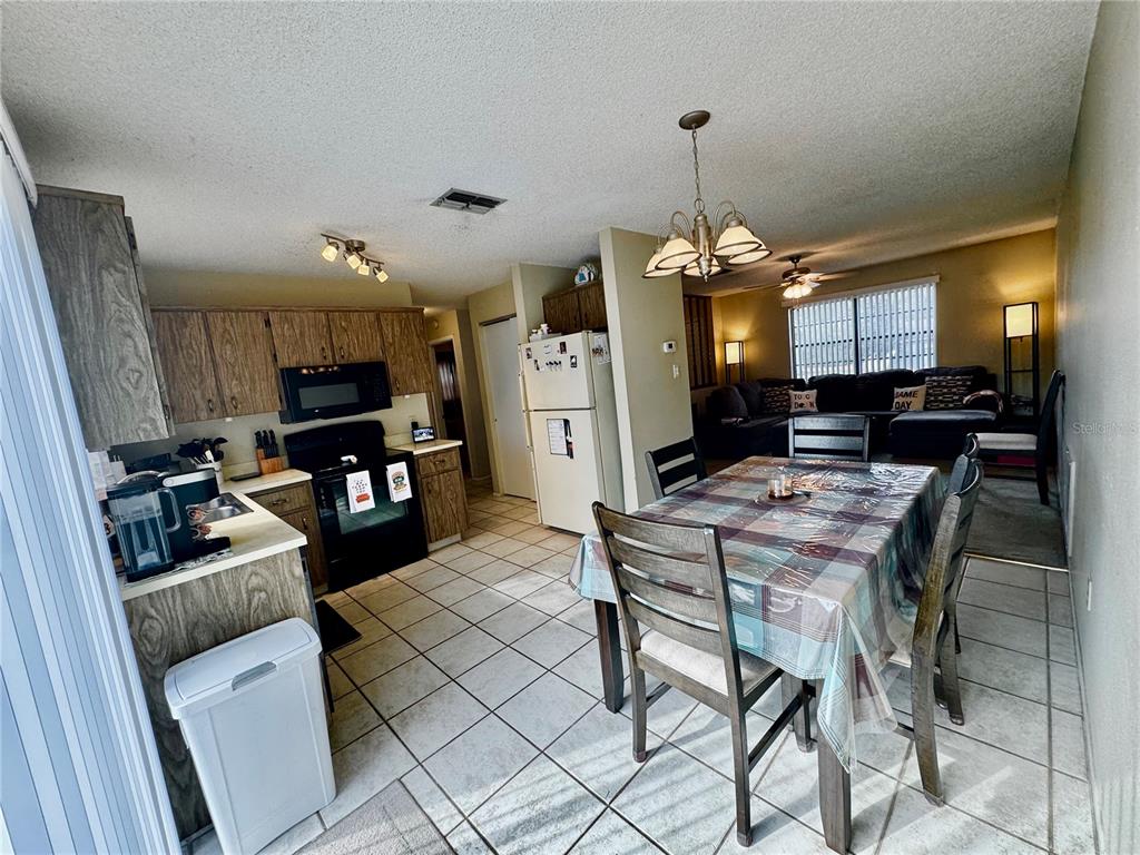 13188 Delbarton Street Spring Hill, FL 34609 - Photo 8 of 23 a view of a dining room with furniture a rug and wooden floor