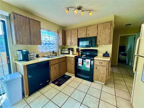 a bedroom with a bed dresser and a window