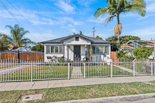 a front view of a house with a garden and plants
