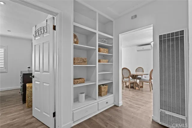 a view of living room with furniture and wooden floor