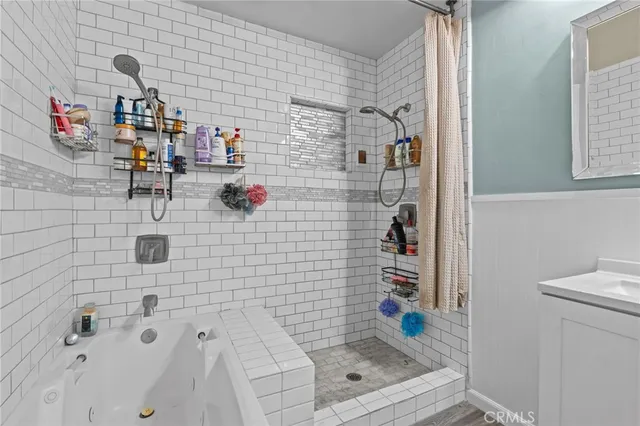 a bathroom with a bathtub and a shower