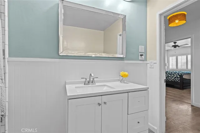 a bathroom with a sink vanity and mirror
