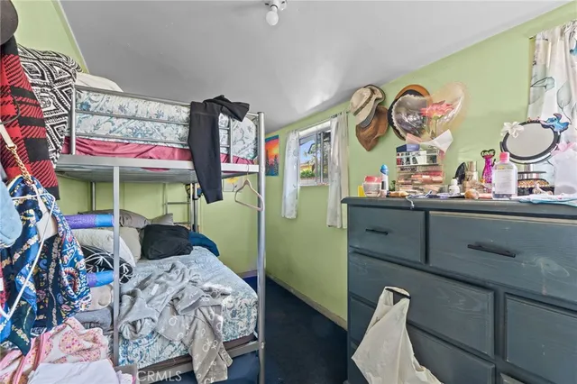 a bedroom with bed and a mirror