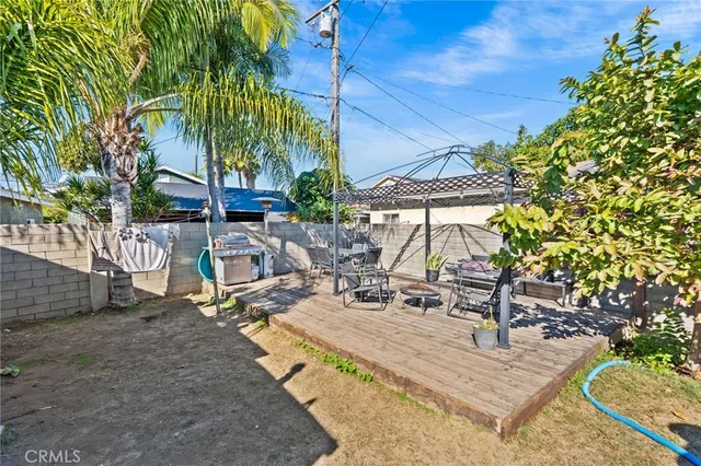 a view of backyard with swimming pool and sitting area