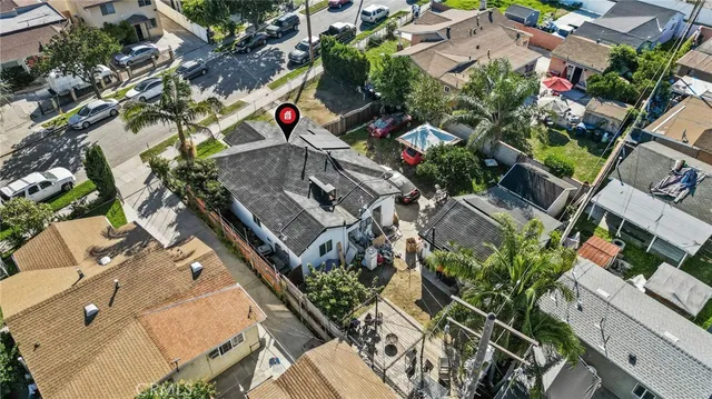 an aerial view of a house with a yard and potted plants