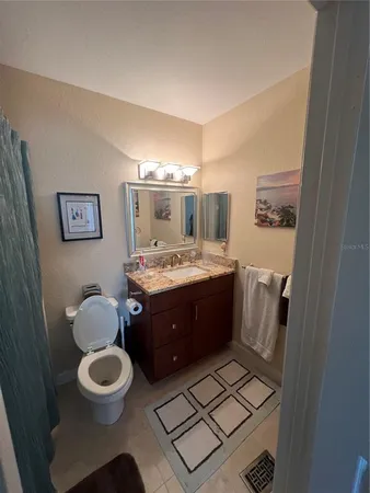 a bathroom with a toilet a sink and mirror