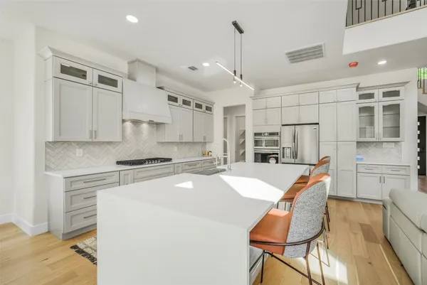 a kitchen with stainless steel appliances a refrigerator and cabinets