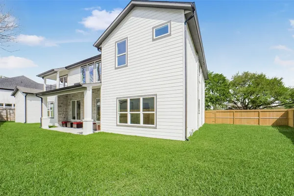 a view of a house with a yard and a garden
