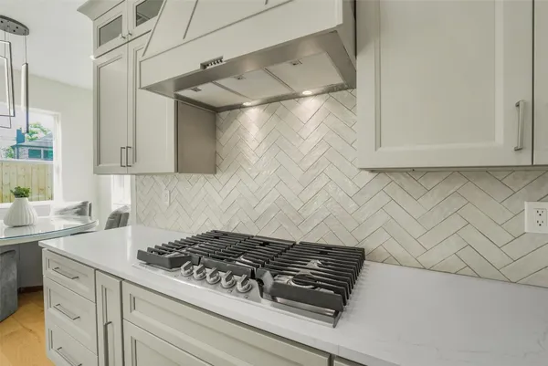 a view of a kitchen counter top space with furniture and wooden floor
