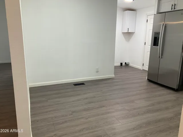 a view of a kitchen with wooden floor and electronic appliances