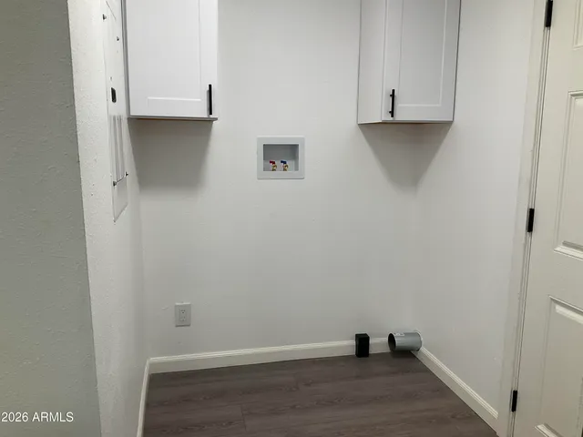 a view of an empty room and wooden floor