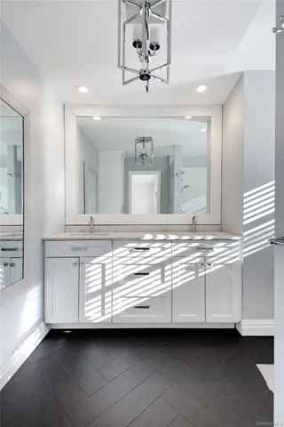 a bathroom with a sink granite and a mirror