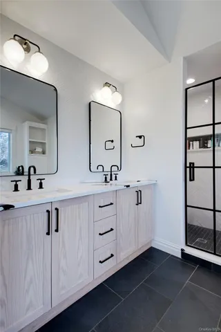 a spacious bathroom with a double vanity sink and mirror