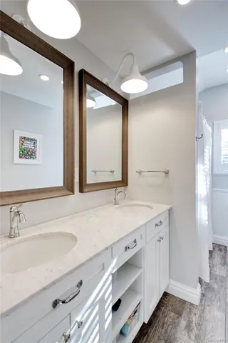 a bathroom with a double vanity sink and a mirror