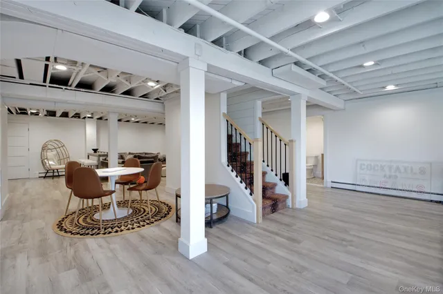 a view of a room with gym equipment and wooden floor