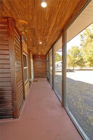 a living room with furniture and large windows