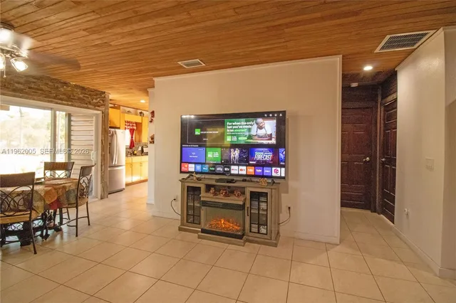 a spacious bedroom with a bed a couch and large windows