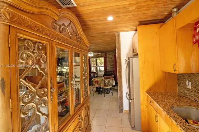 a hallway with dining table and chairs