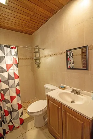 a bathroom with a sink mirror and toilet