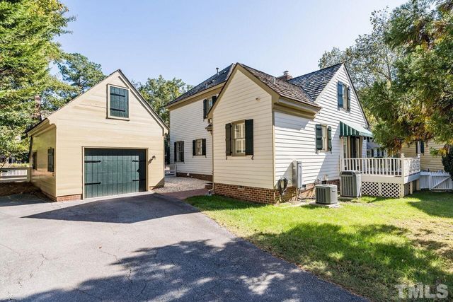 a front view of a house with a yard and outdoor seating