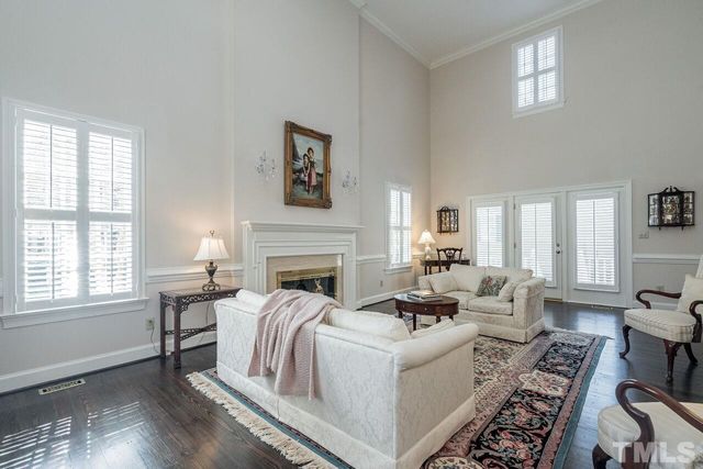 a living room with furniture a fireplace and a window