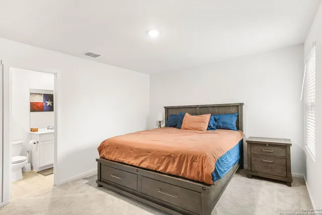 a bedroom with a bed and a cabinets