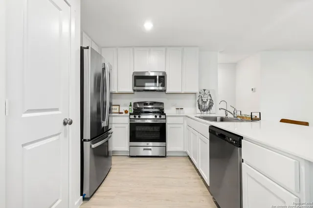 a kitchen with a sink a stove and refrigerator