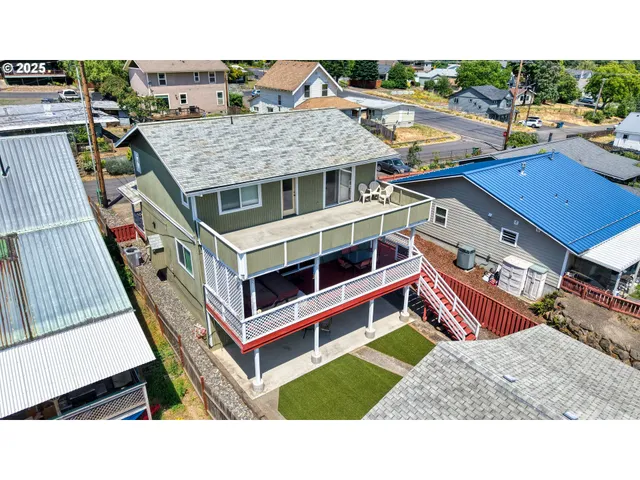 a view of a balcony with wooden floor and city view