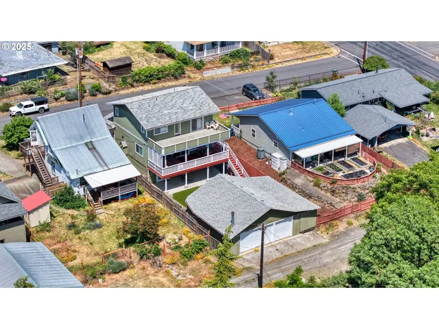an aerial view of a houses with a big yard