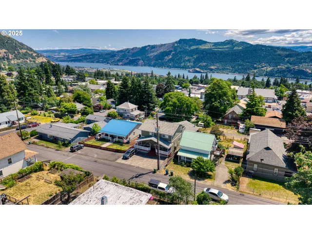 an aerial view of a house with a garden space and street view