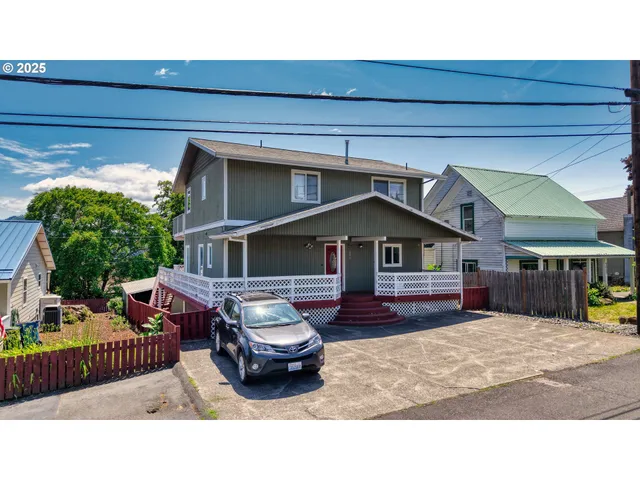 a black and white photo of a house with a yard