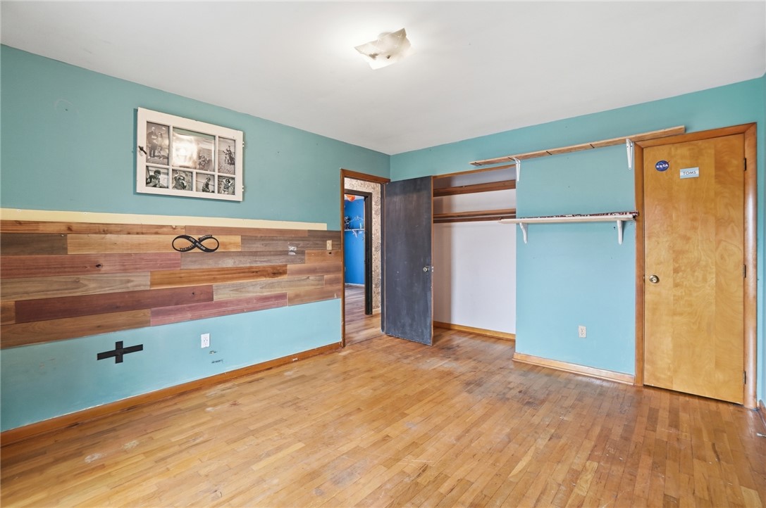 290 Ginghamsburg Road Tipp City, OH 45371 - Photo 22 of 49 This spacious bedroom features classic hardwood floors and an open closet, perfect for personalizing your living space.
