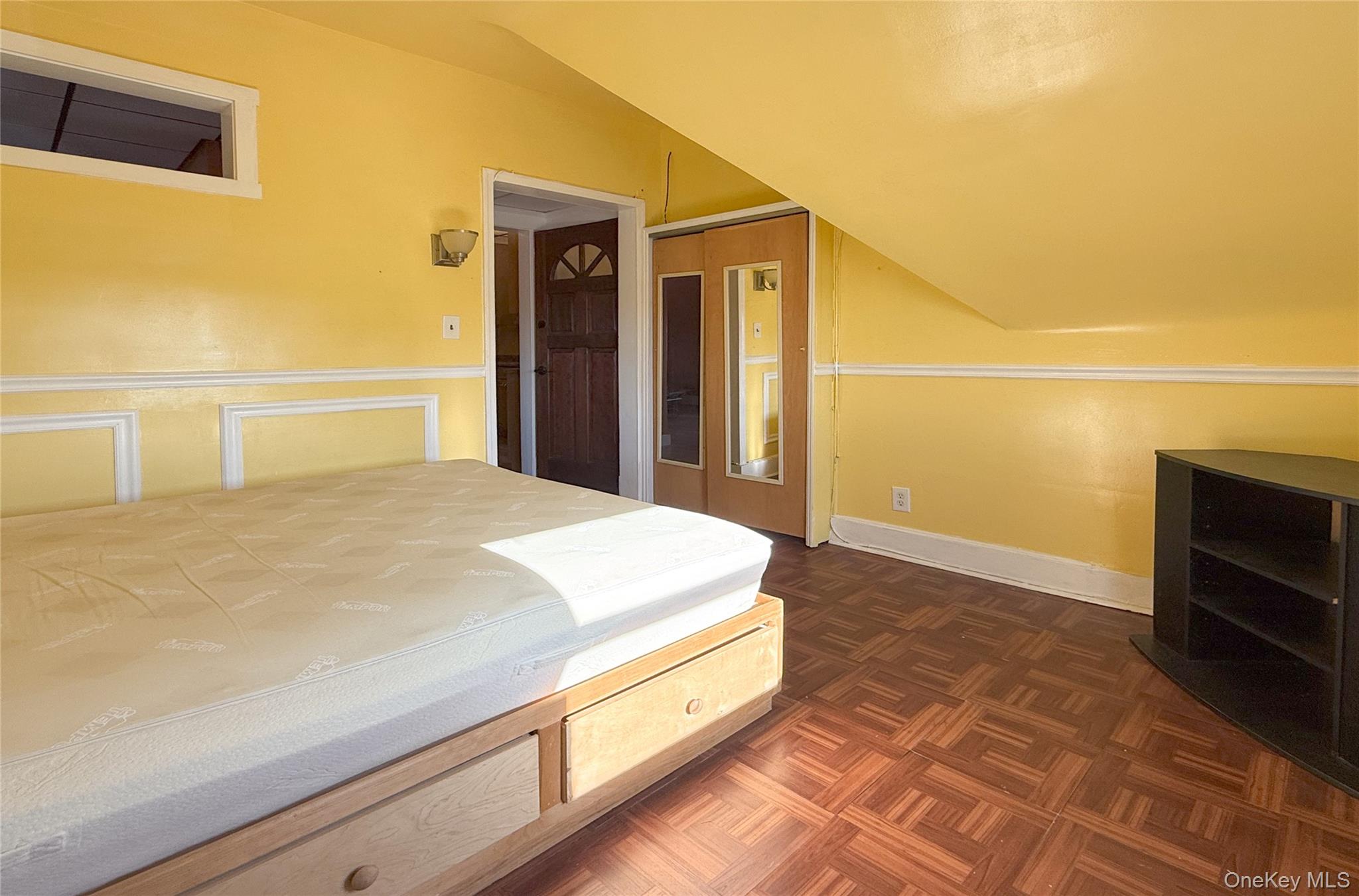 134-37 58th Road Queens, NY 11355 - Photo 16 of 24 Bedroom featuring lofted ceiling and baseboards