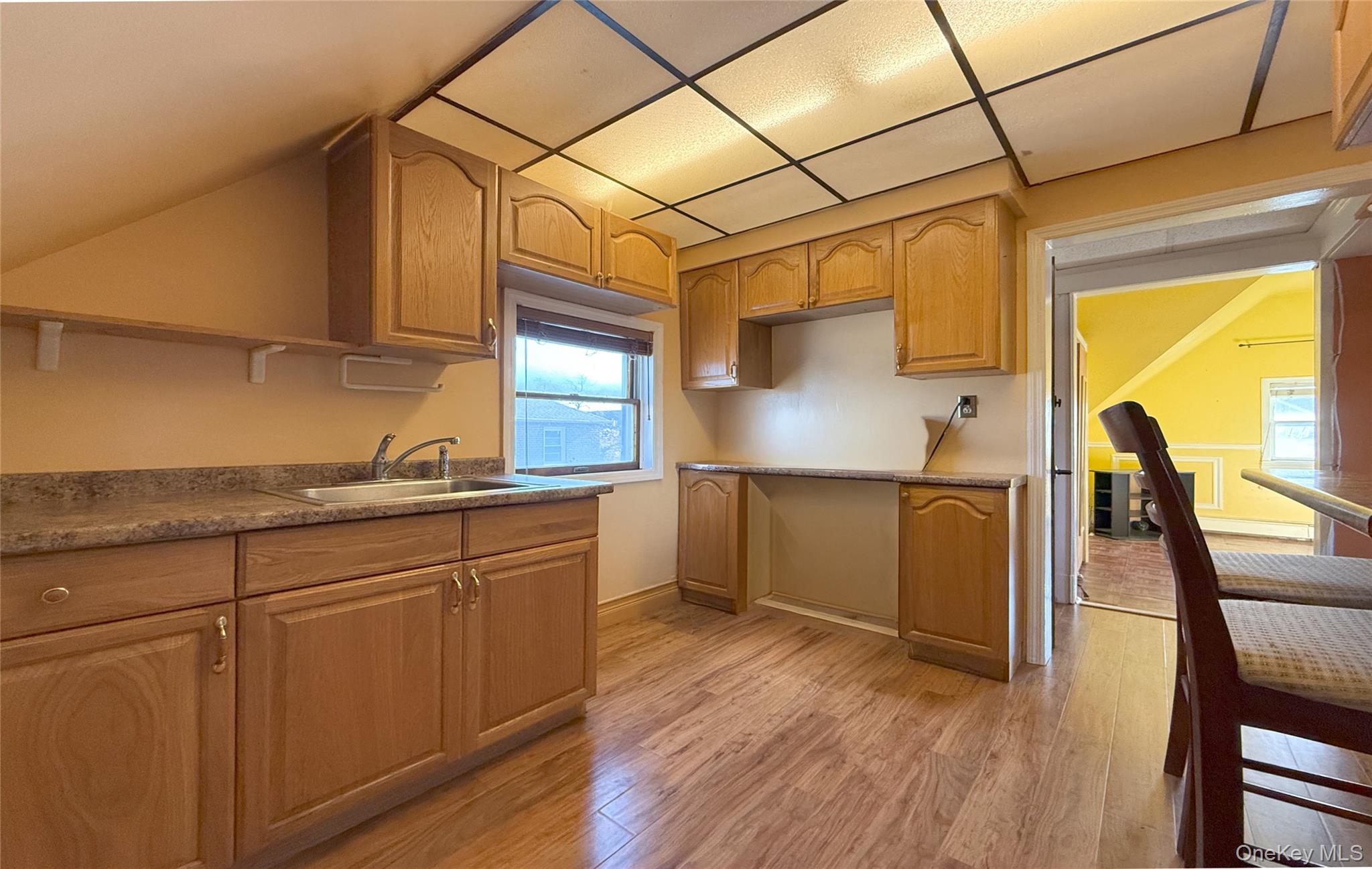 134-37 58th Road Queens, NY 11355 - Photo 21 of 24 Kitchen featuring light wood-style floors, a drop ceiling, dark countertops, and open shelves