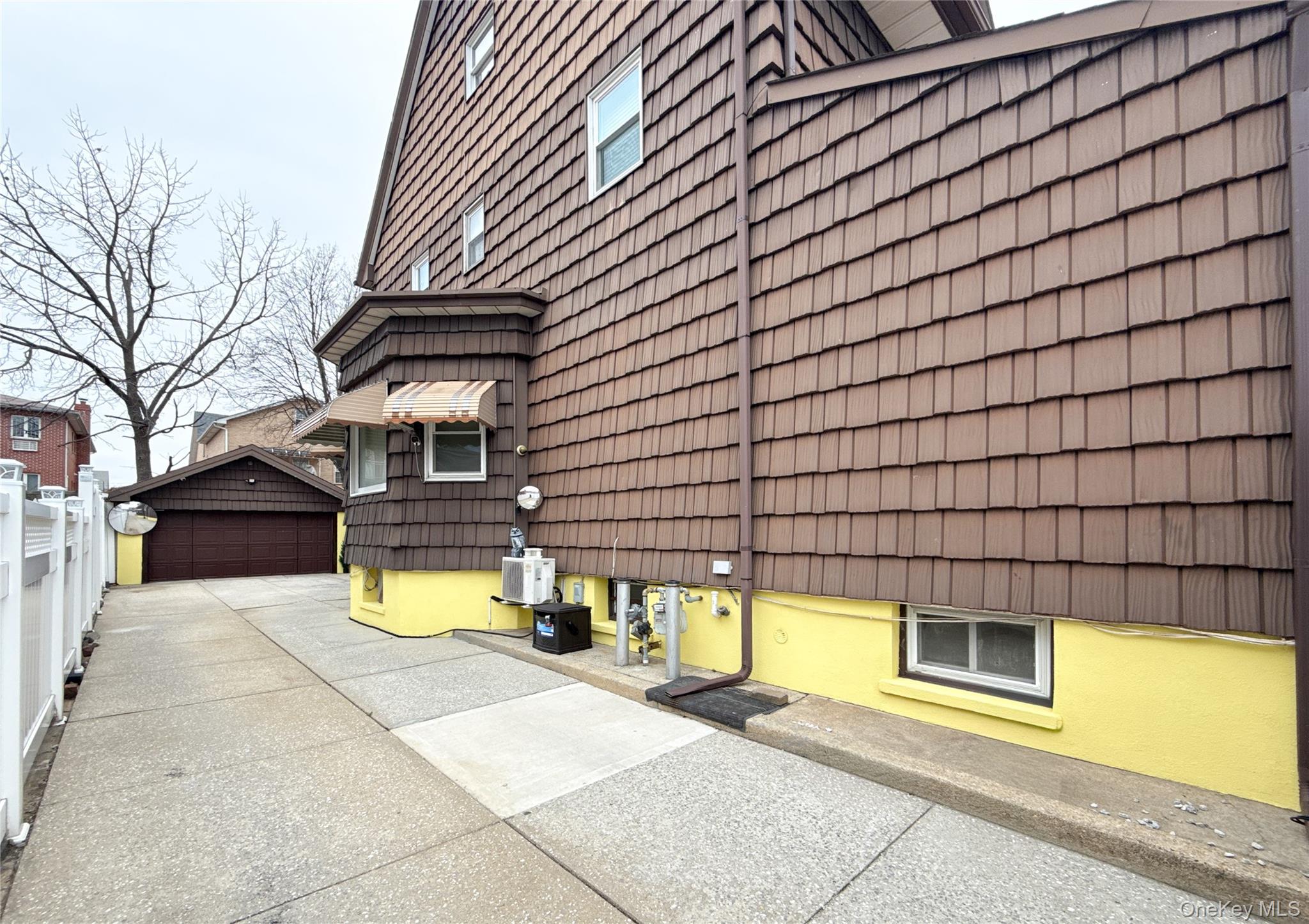 134-37 58th Road Queens, NY 11355 - Photo 5 of 24 View of property exterior featuring a garage and an outdoor structure