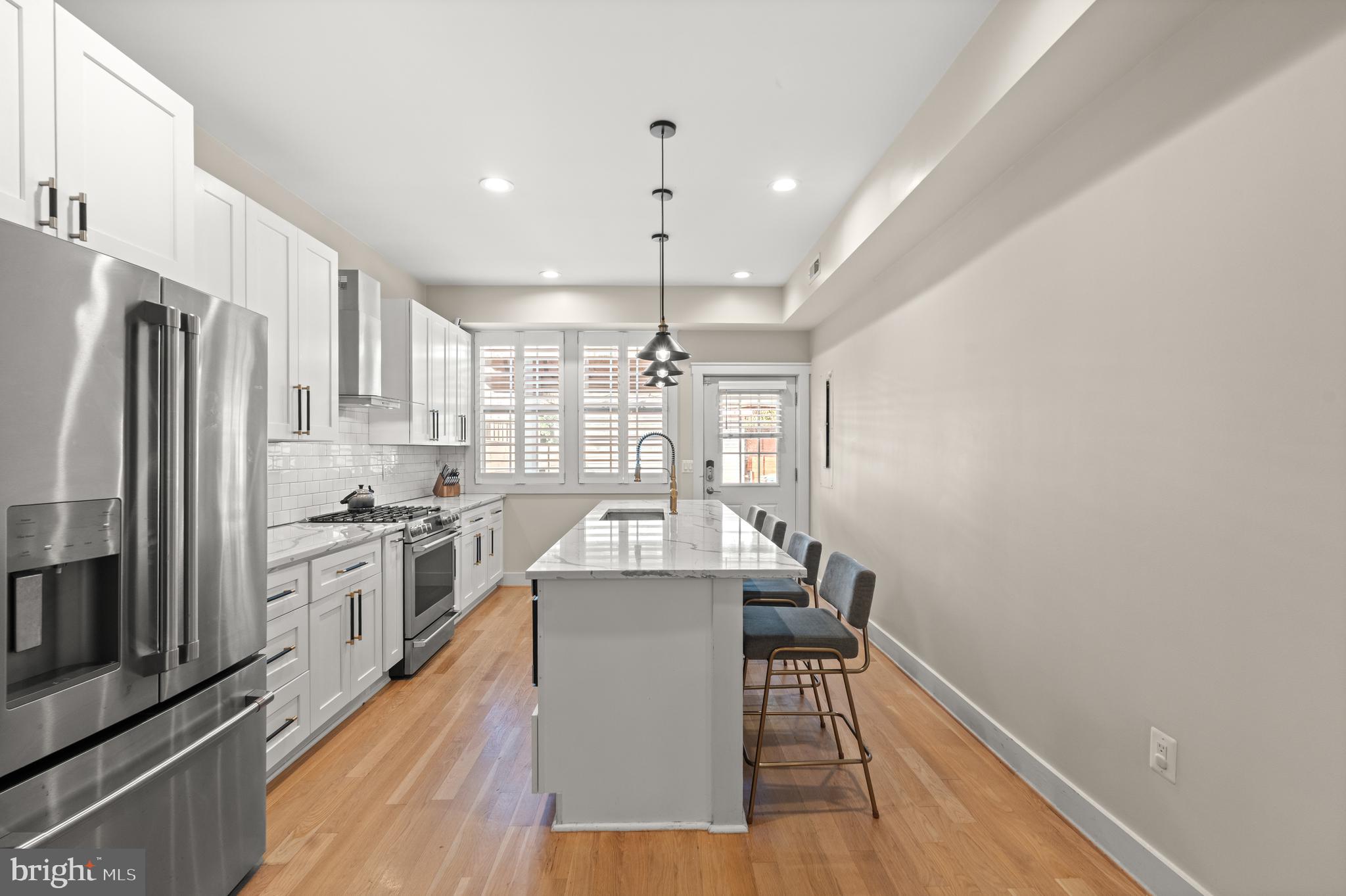 4718 15th Street Northwest Washington, DC 20011 - Photo 13 of 49 a kitchen with kitchen island a counter top space a sink stainless steel appliances and cabinets