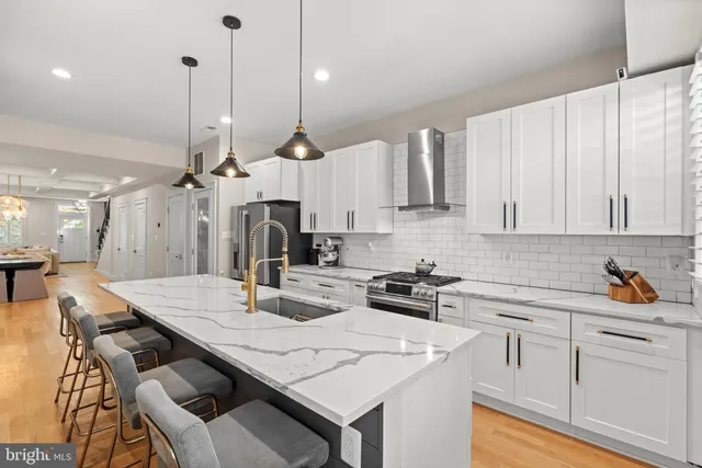 a kitchen with a white center island and cabinets