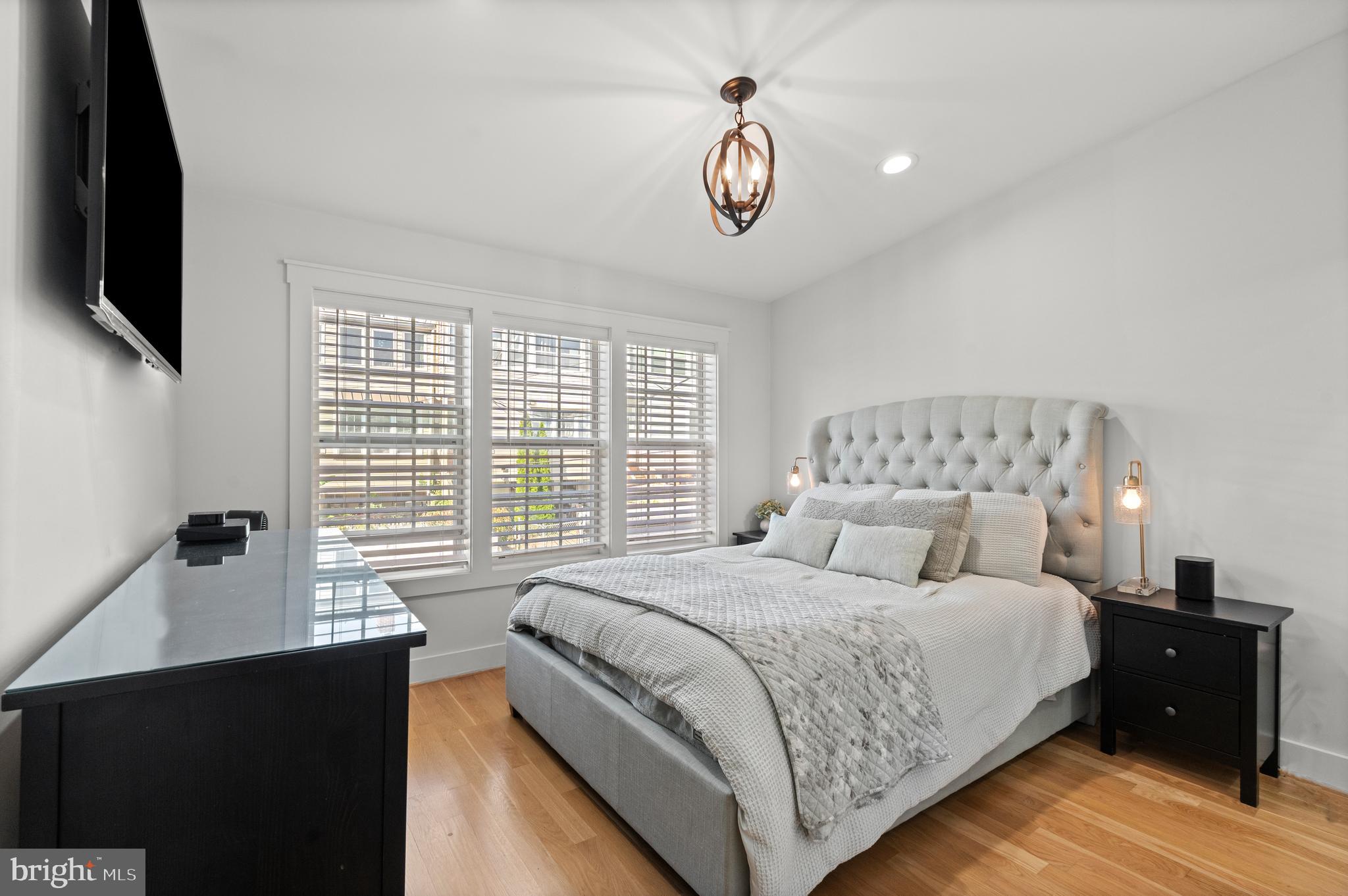 4718 15th Street Northwest Washington, DC 20011 - Photo 20 of 49 a bedroom with a bed and a flat tv screen on dresser