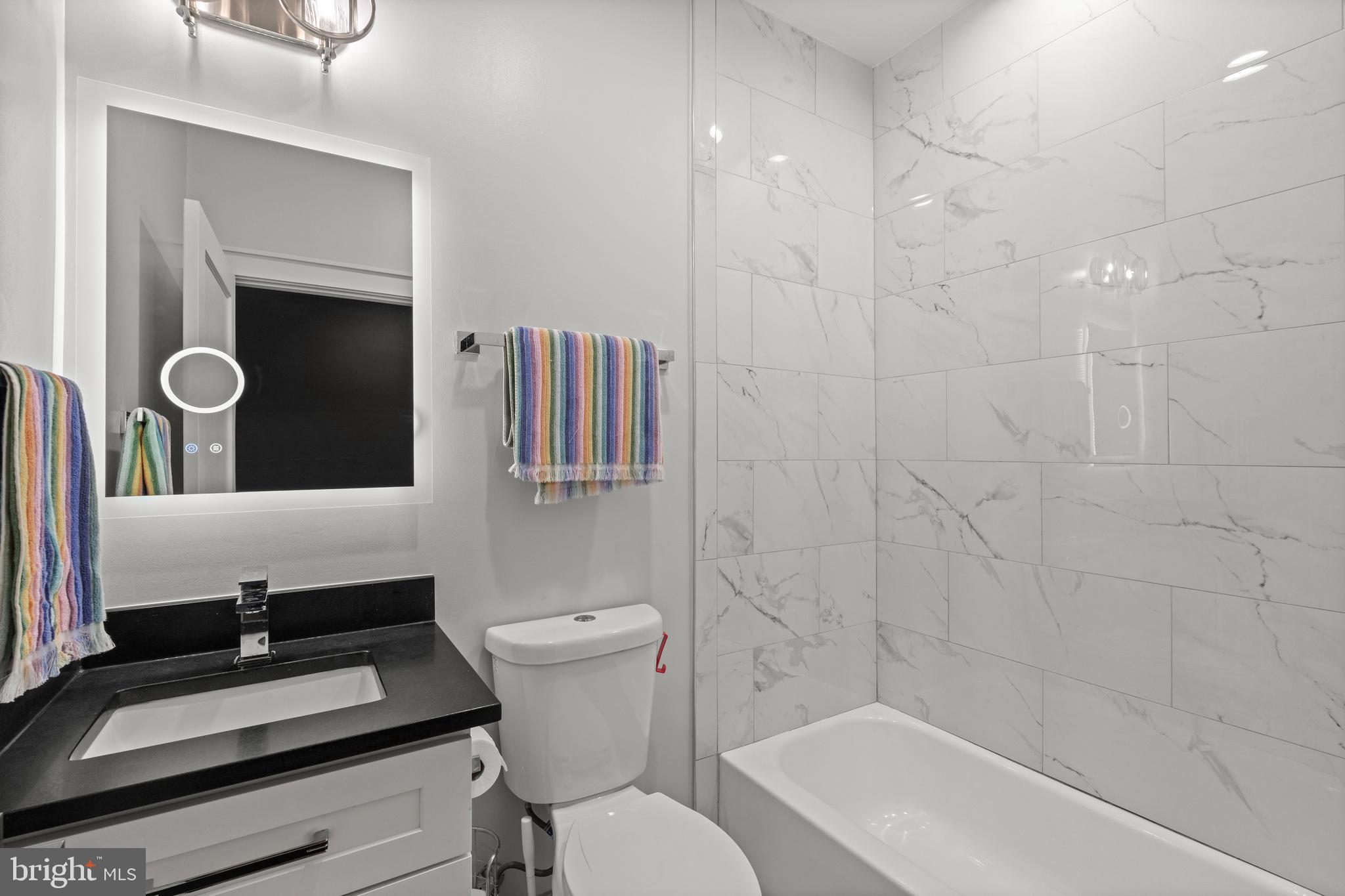 4718 15th Street Northwest Washington, DC 20011 - Photo 25 of 49 a bathroom with a sink a toilet and shower