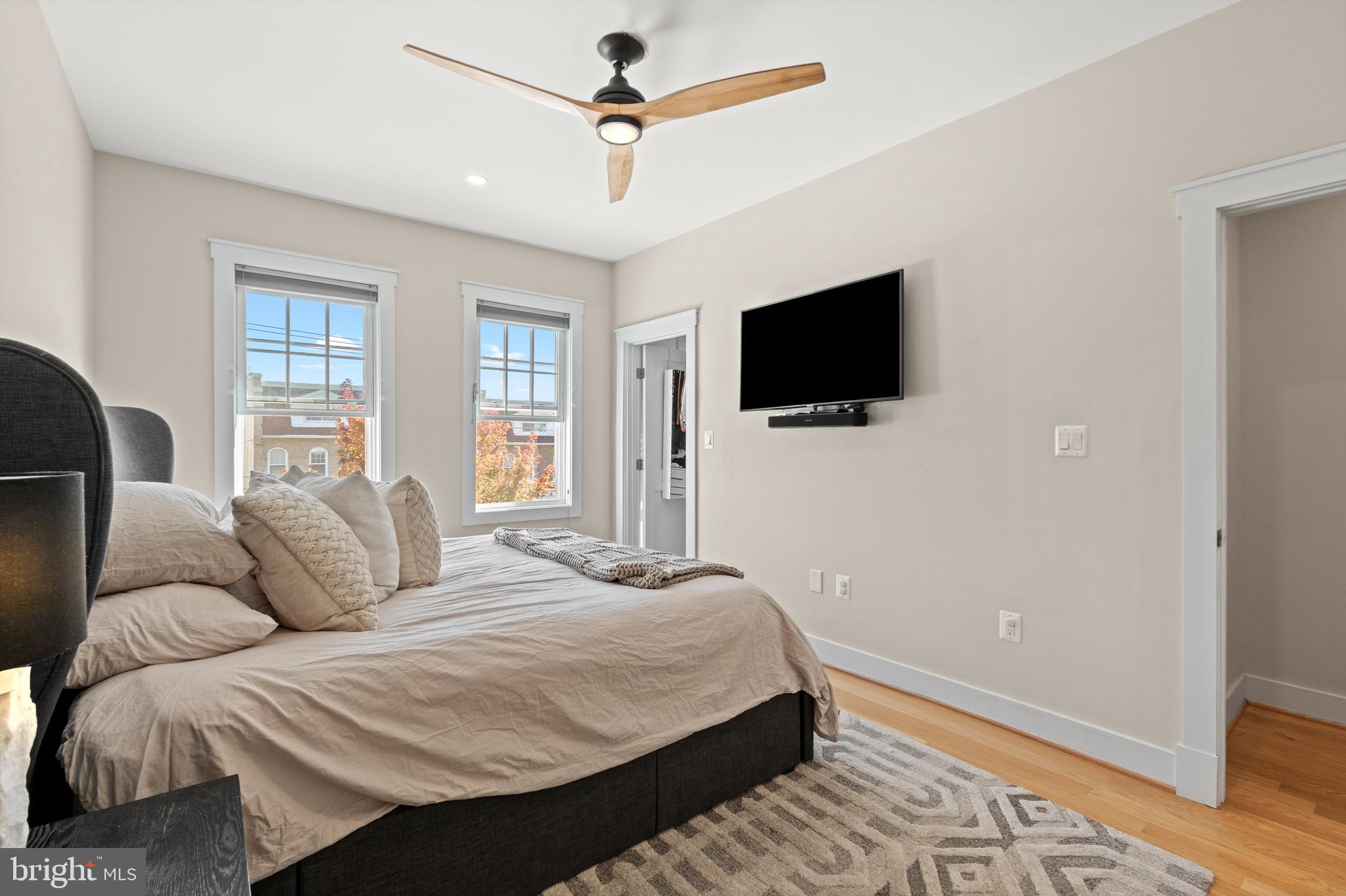 4718 15th Street Northwest Washington, DC 20011 - Photo 29 of 49 a bedroom with a bed a flat screen tv and a window