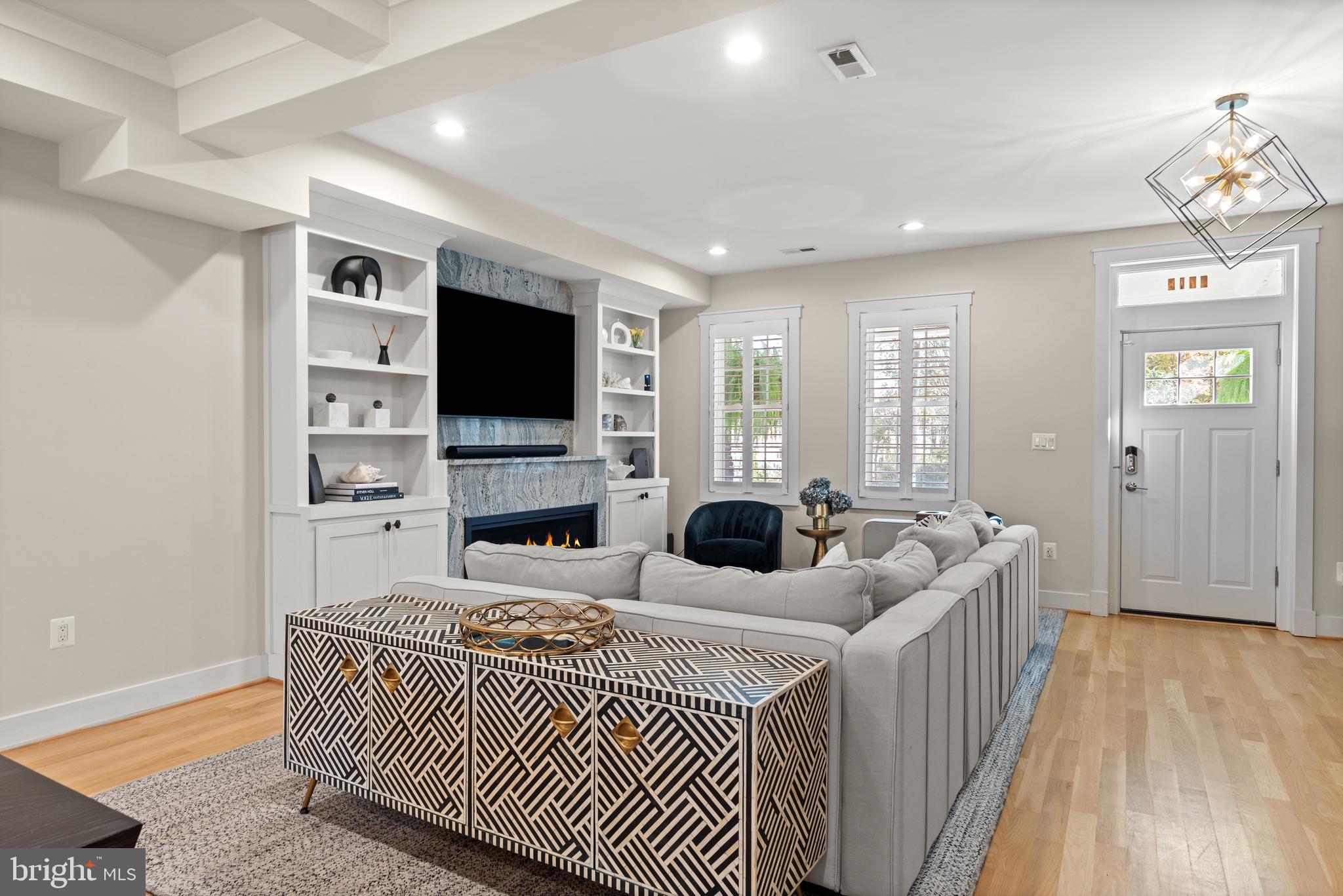 4718 15th Street Northwest Washington, DC 20011 - Photo 7 of 49 a living room with furniture a fireplace and a flat screen tv